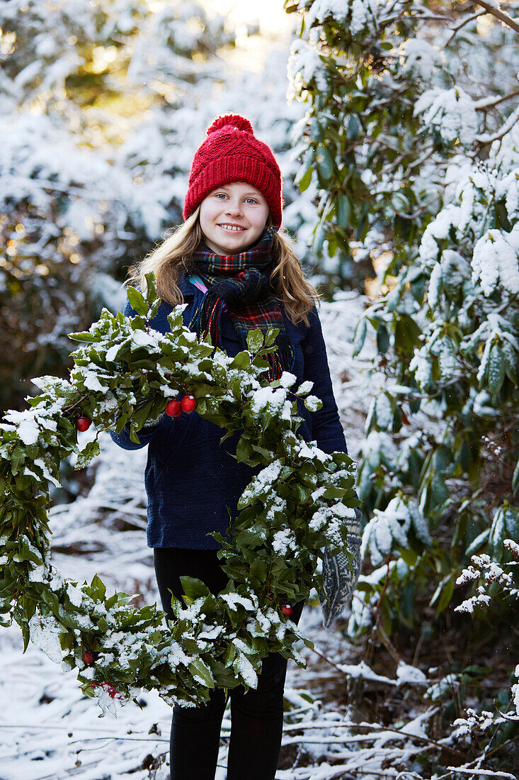 Girl holding Christmas wreath