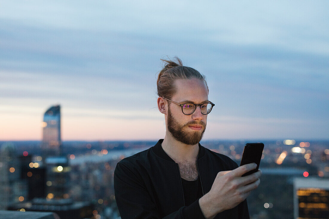 Man using smartphone in city