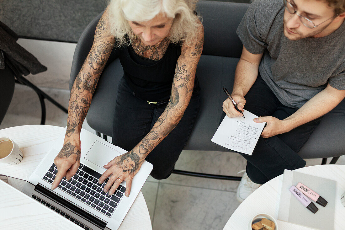 Man and woman working on laptop