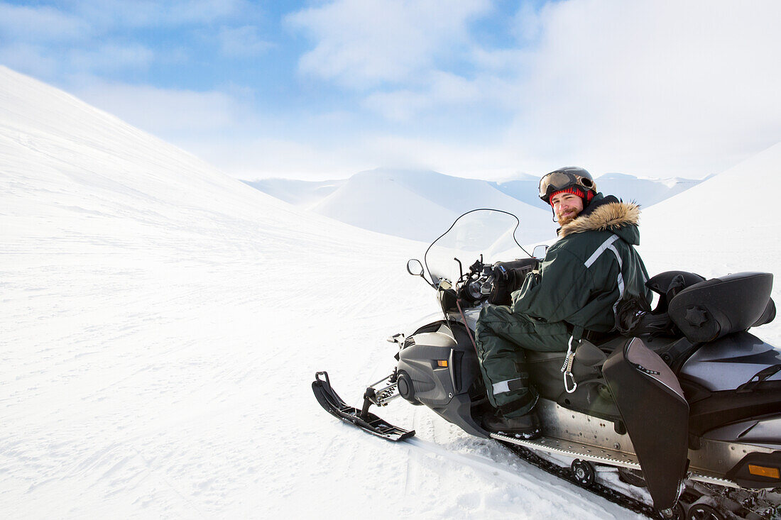 Man sitting on snowmobile