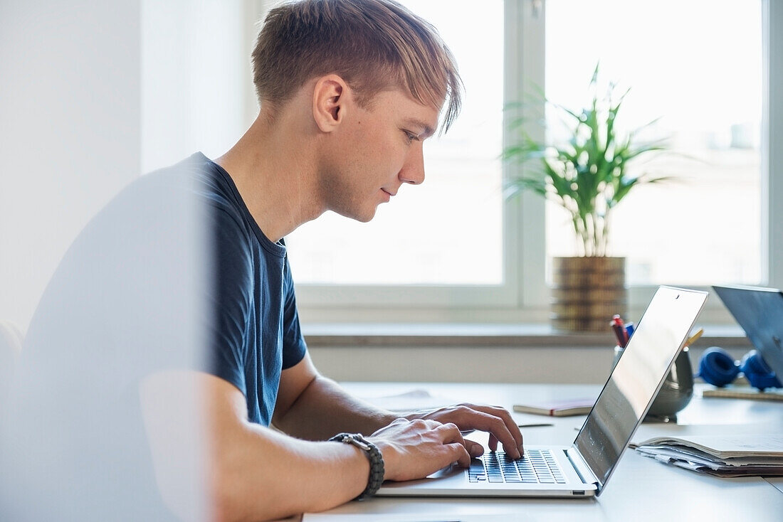 Man working on laptop in office