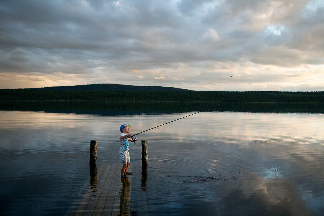 Boy fishing in lake