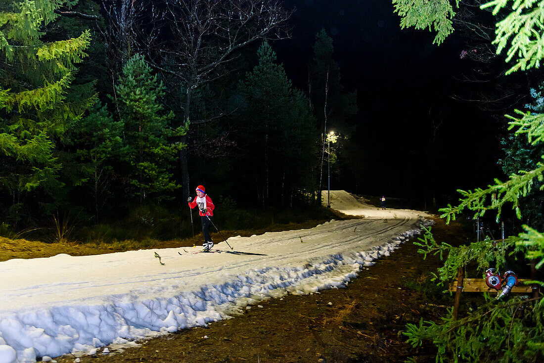 Boy cross country skiing at night