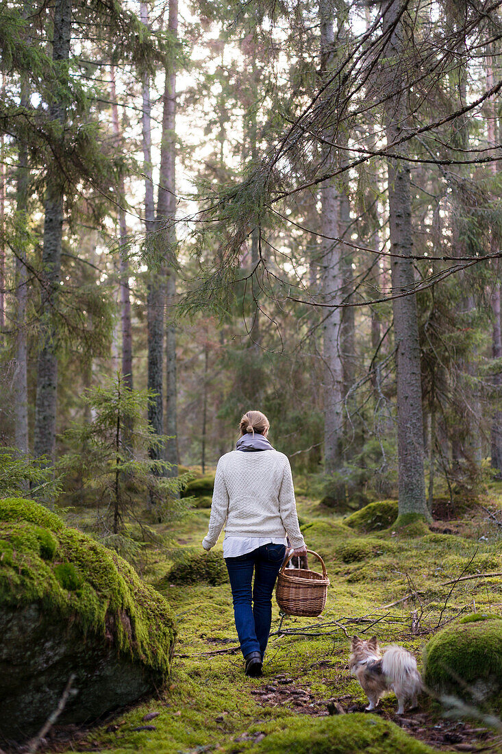 Woman walking through forest