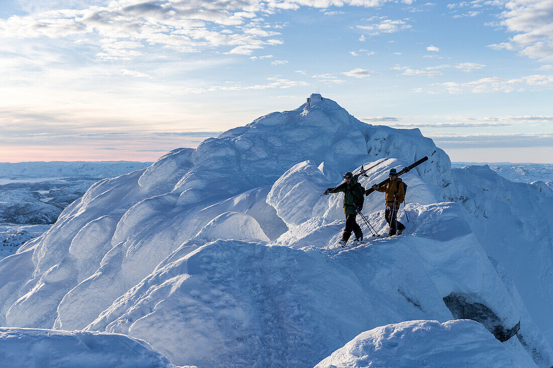 Men walking with skis in mountains