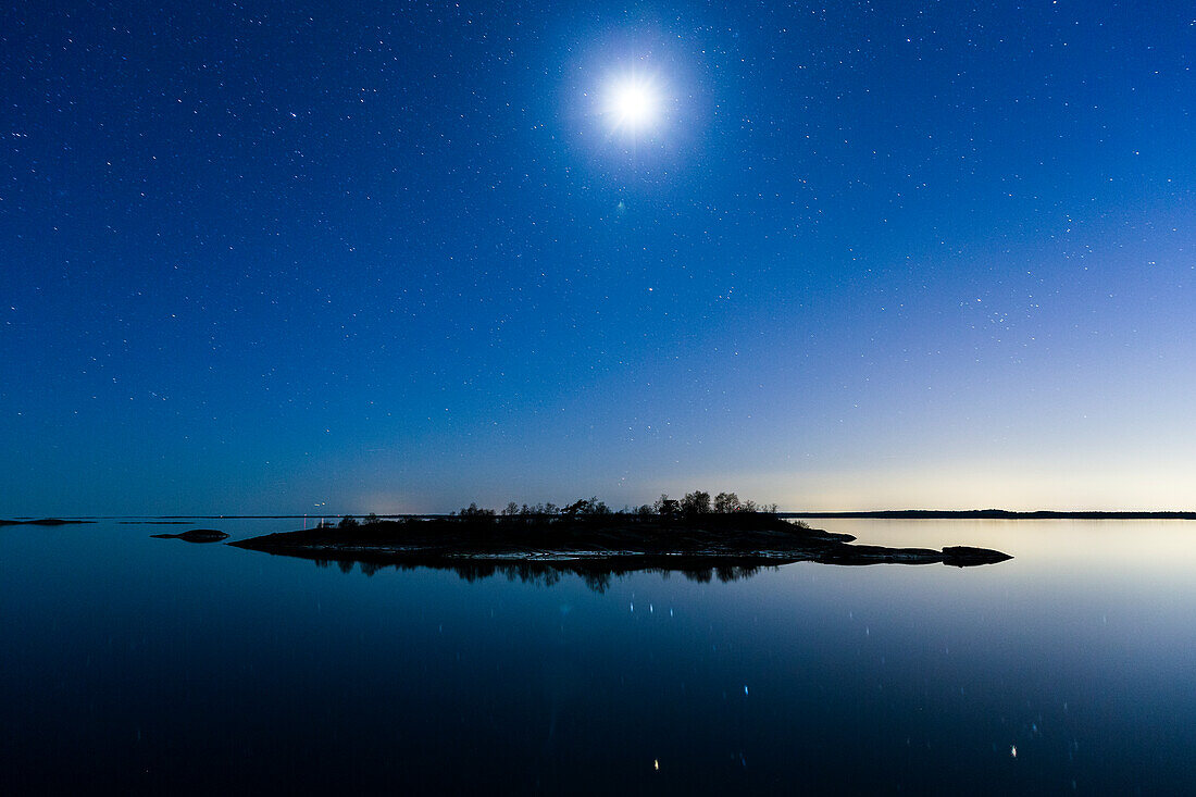 Moon above lake and island