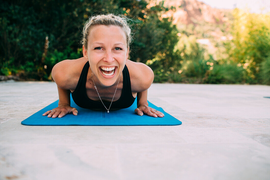 Young woman exercising on veranda