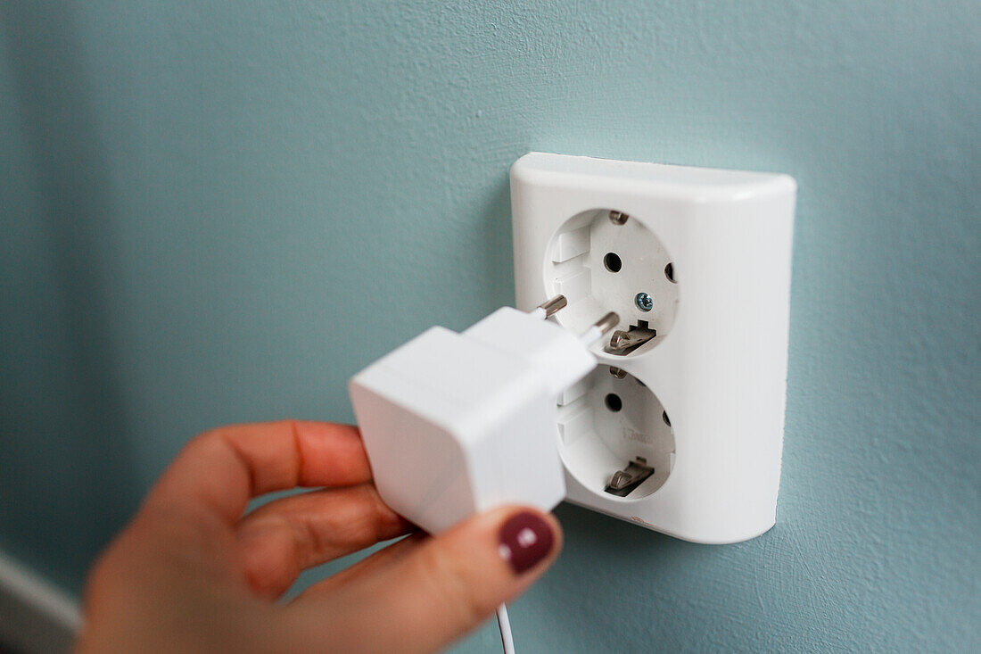 Woman holding plug