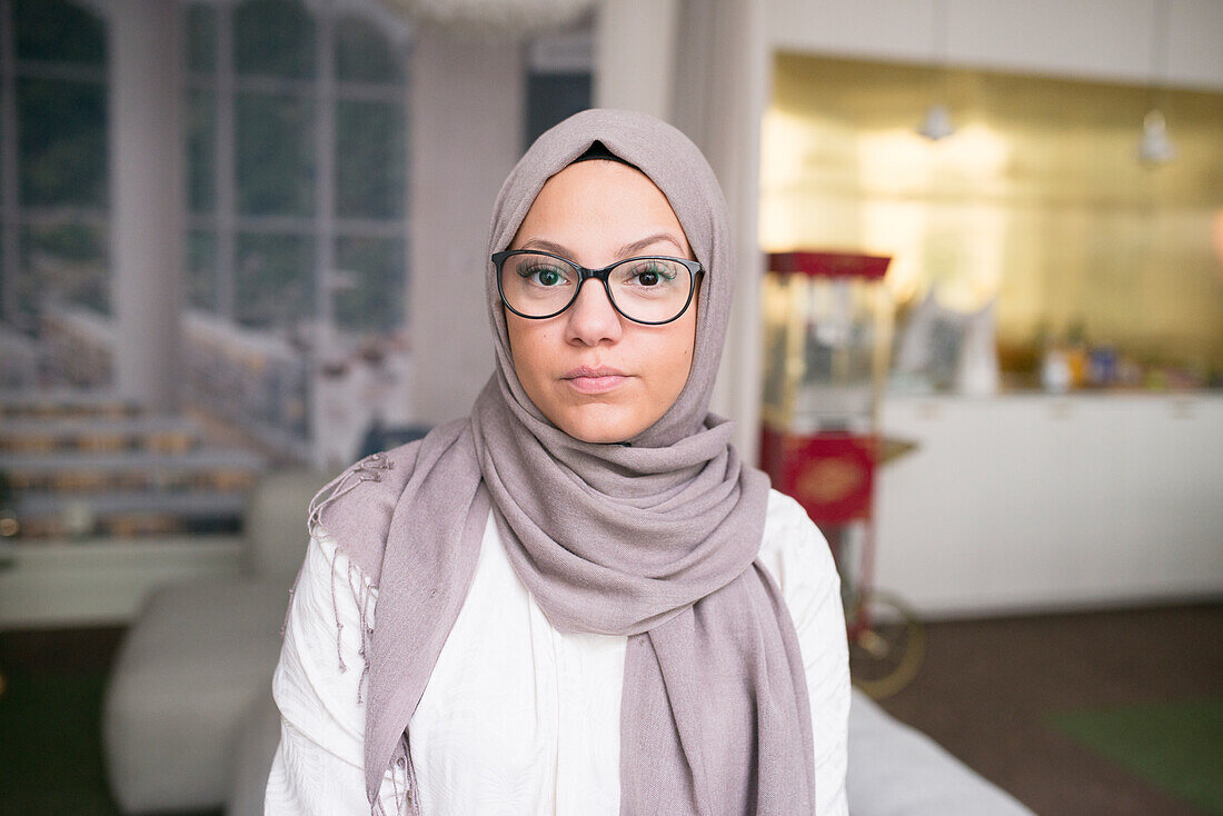 Young woman looking at camera in office