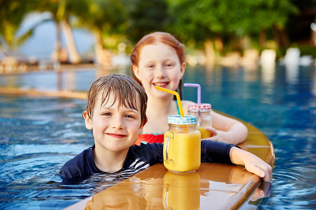 Happy boy and girl in swimming-pool