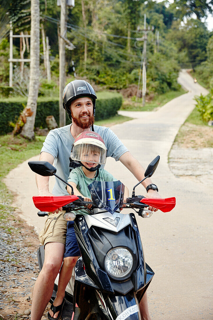 Father and son on scooter