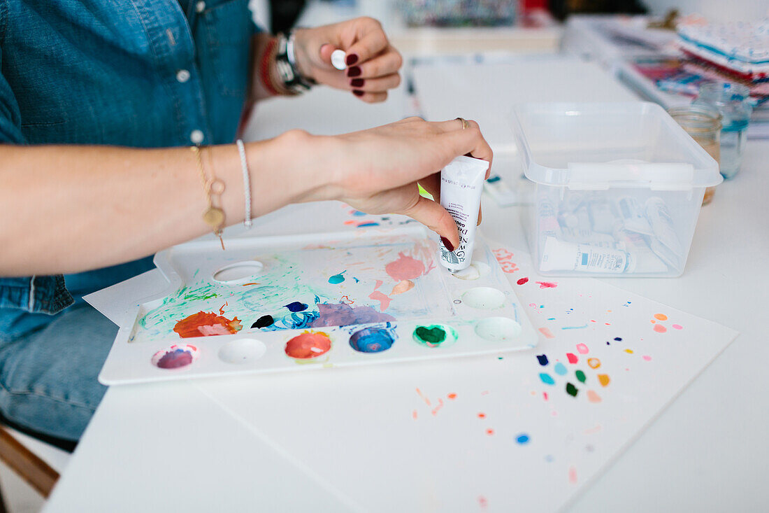 Young woman painting with watercolour