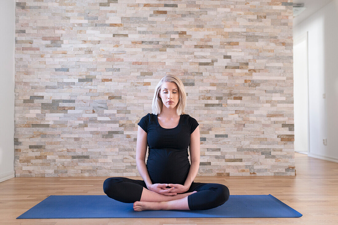 Pregnant woman practicing yoga