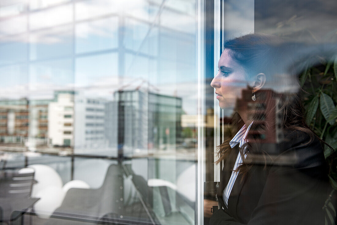 Woman looking through window