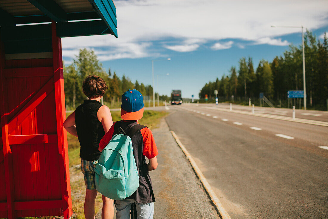 Mother and son on bus stop