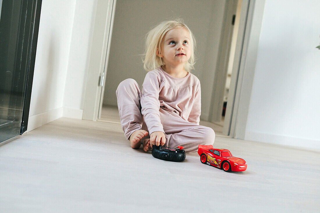 Girl playing with cars