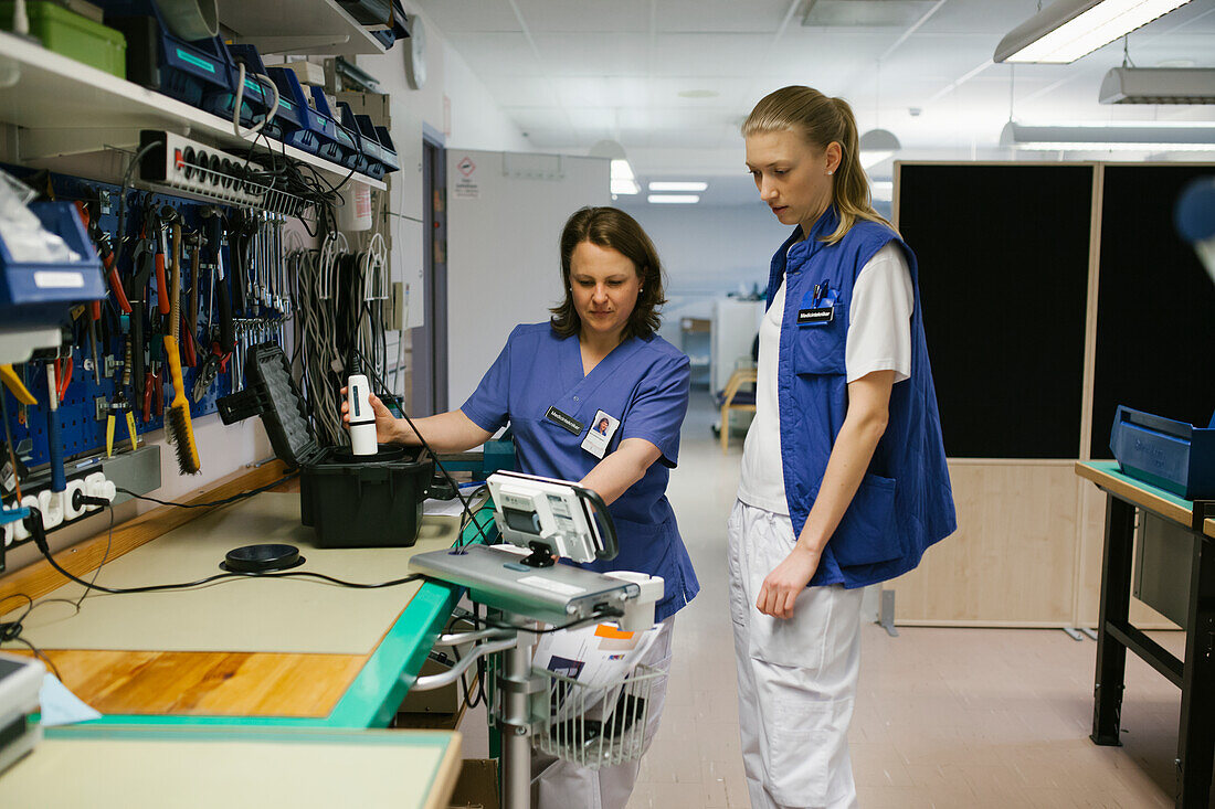 Female engineers checking hospital equipment