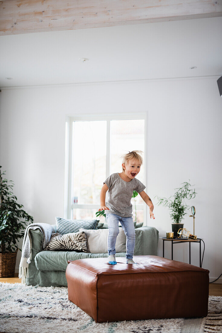 Boy playing on sofa