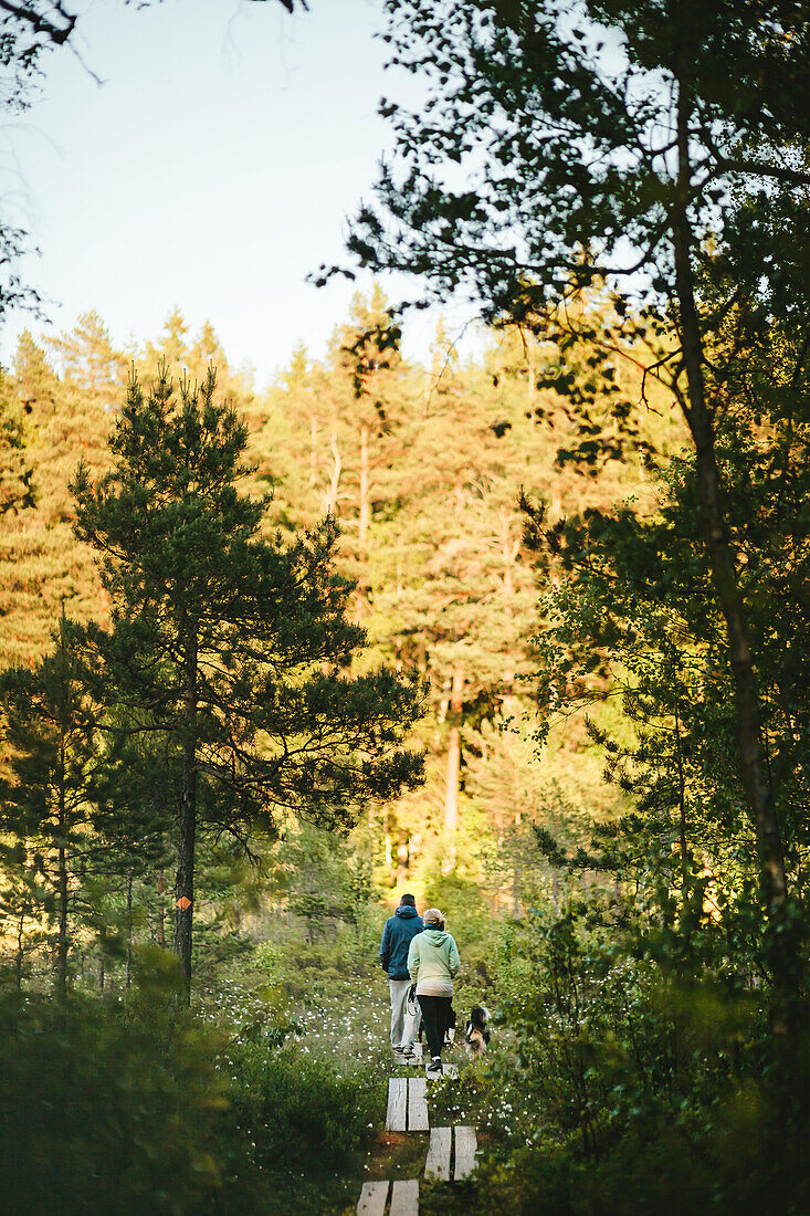 Couple walking through forest