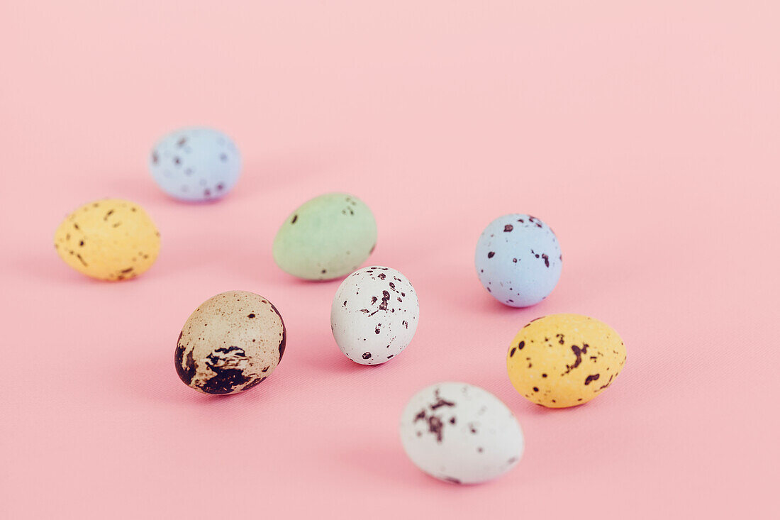 Colorful eggs on pink background