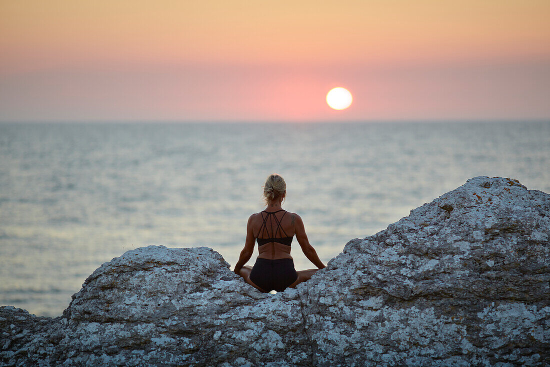 Woman meditating at sea