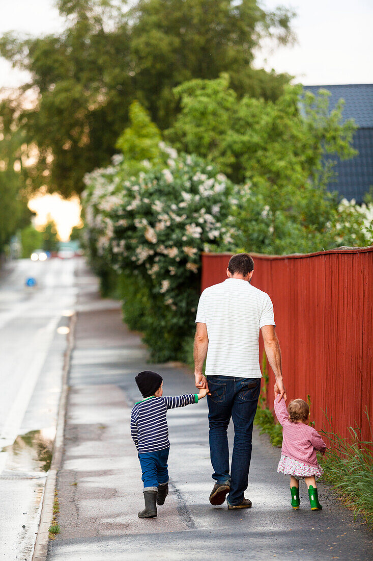 Father walking with kids