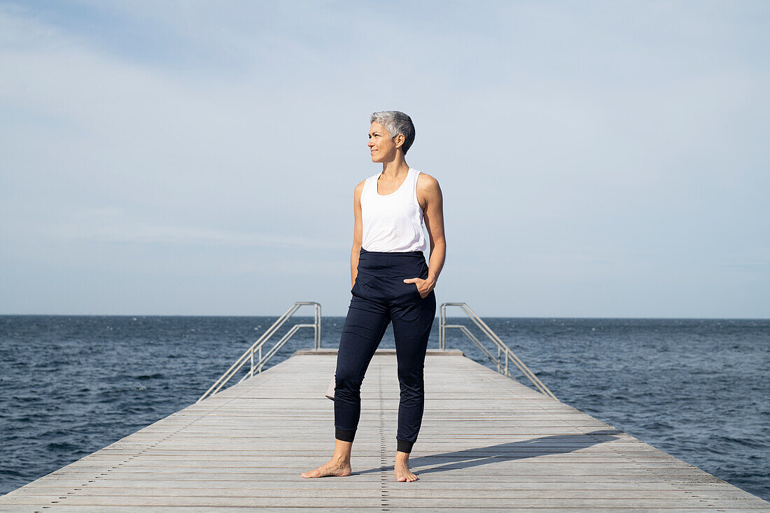 Woman standing on pier