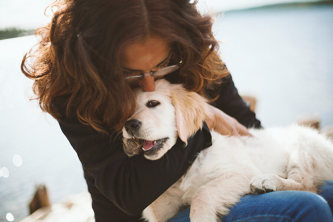 Woman playing with puppy