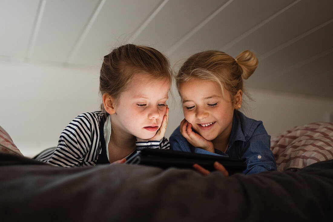 Girls using digital tablet
