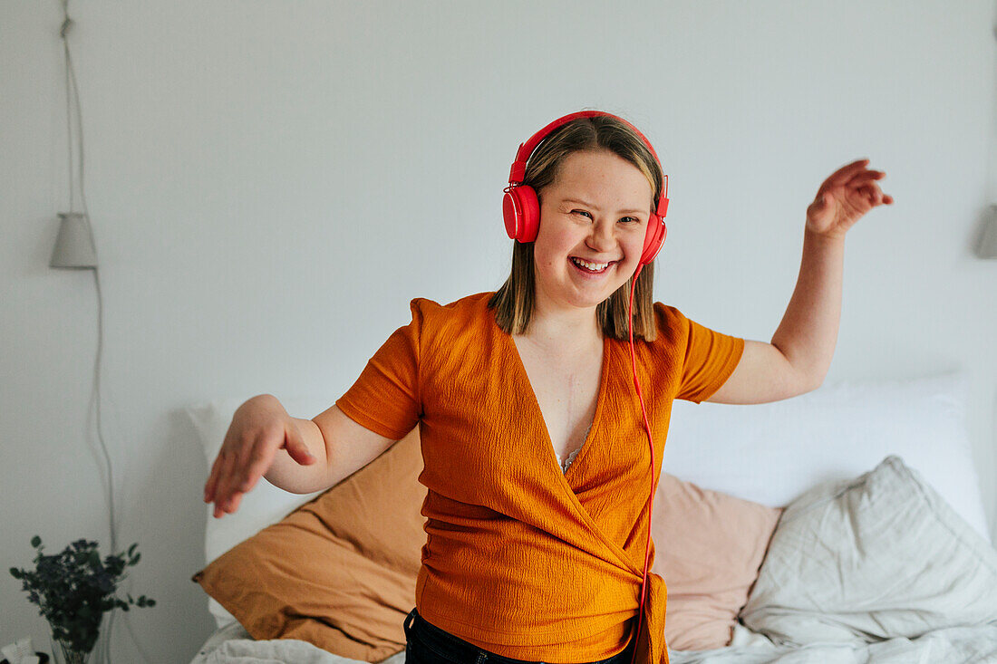 Girl with headphones dancing to music