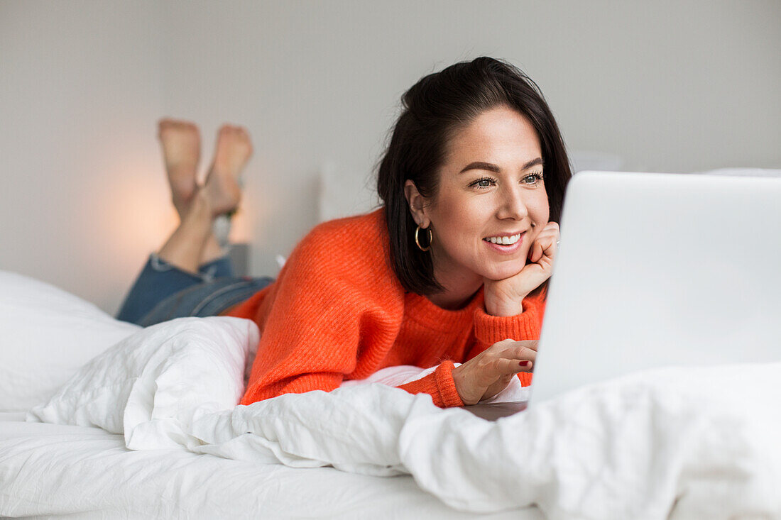 Smiling woman on bed