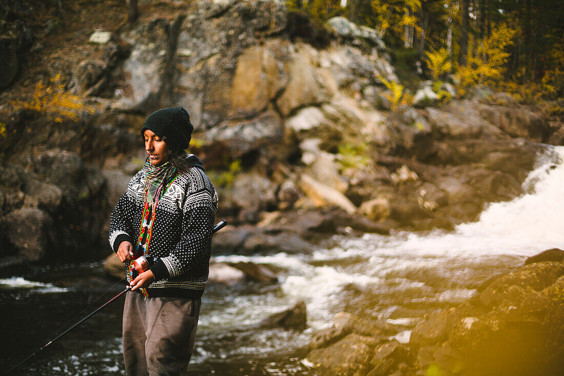 Woman fishing in river