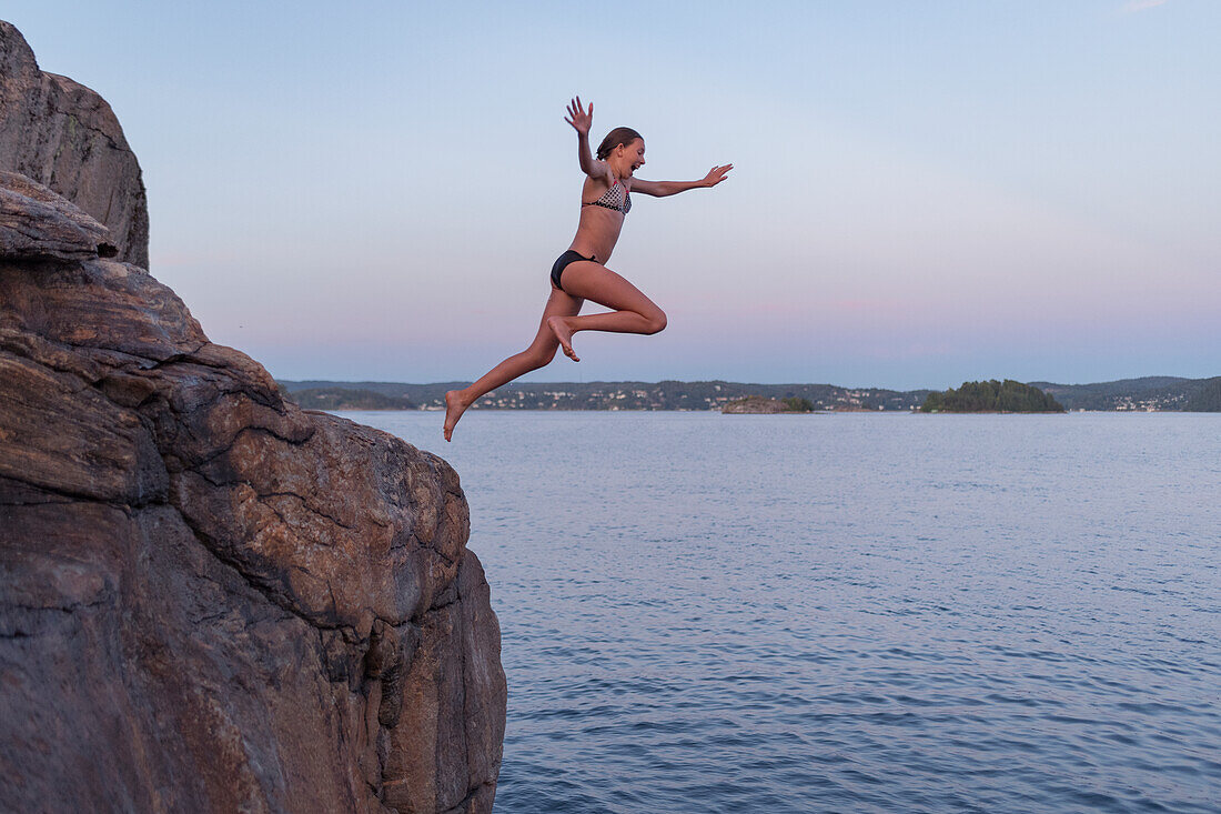 Girl jumping into sea