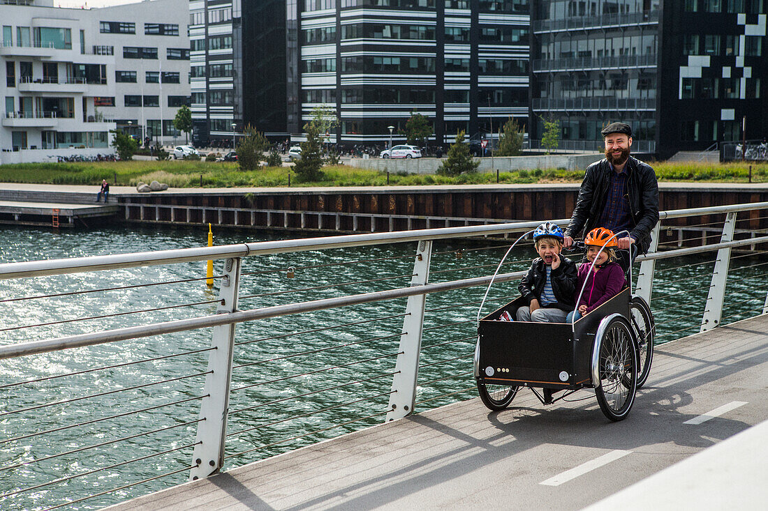 Father with children cycling