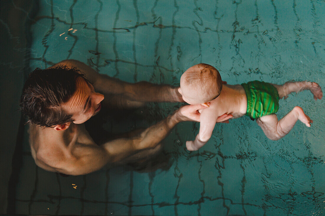 Father with baby in swimming-pool