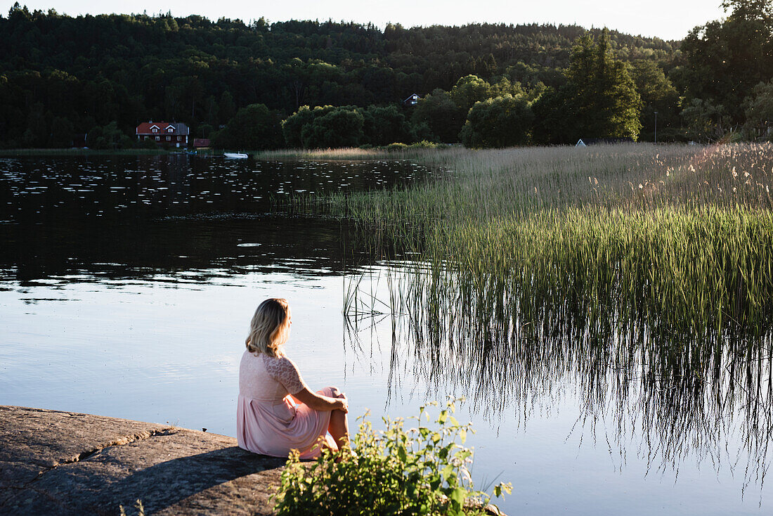 Woman sitting at lake