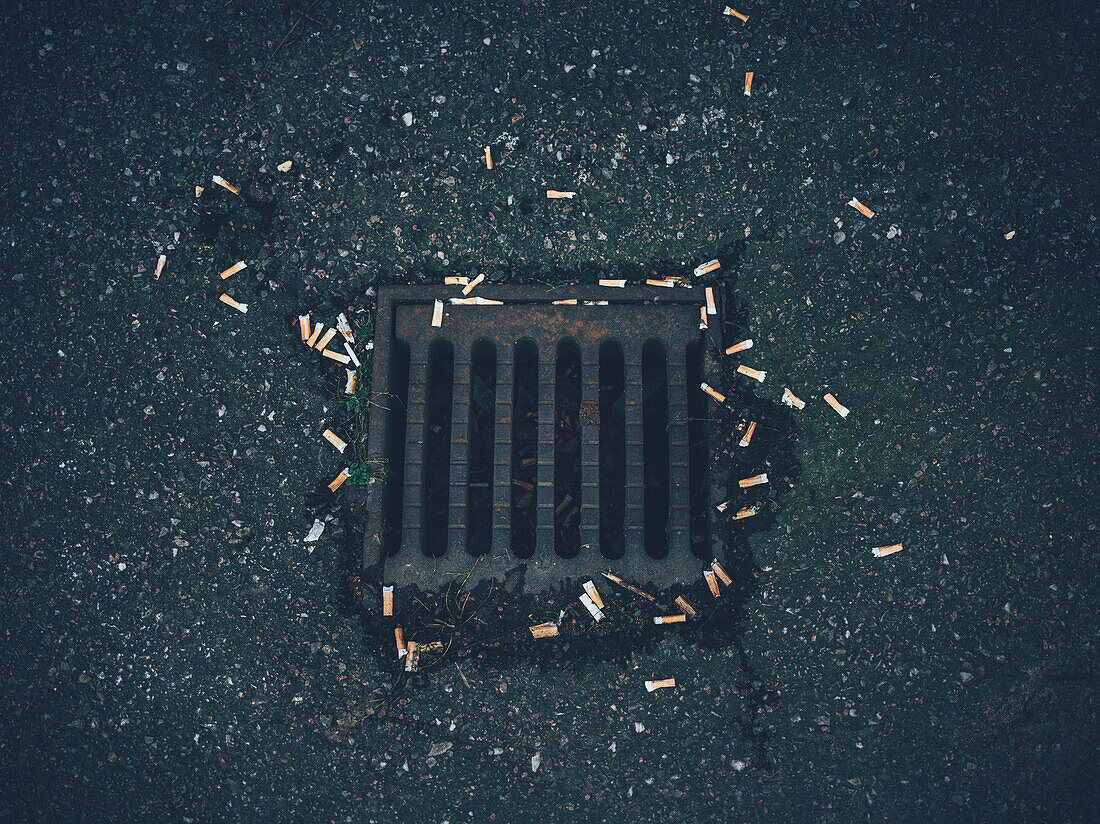 Cigarette butts by drain