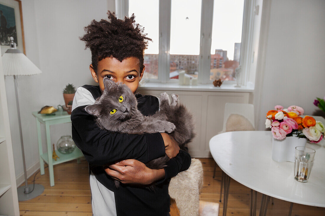 Boy holding cat