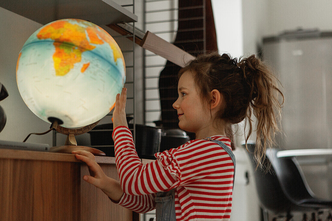 Girl looking at globe