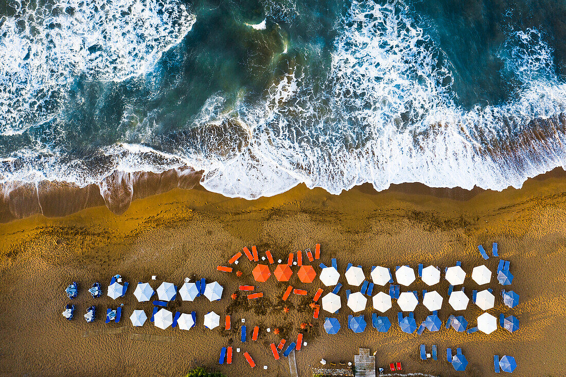 Aerial view of beach umbrellas and sea