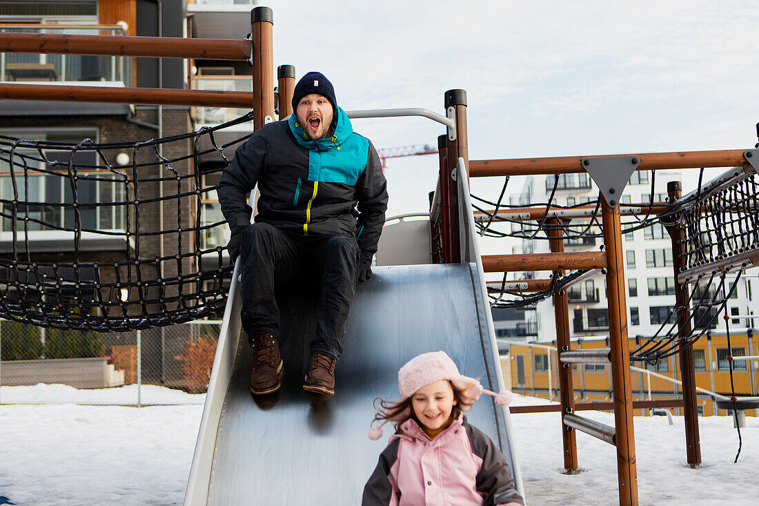 Father with daughter on slide