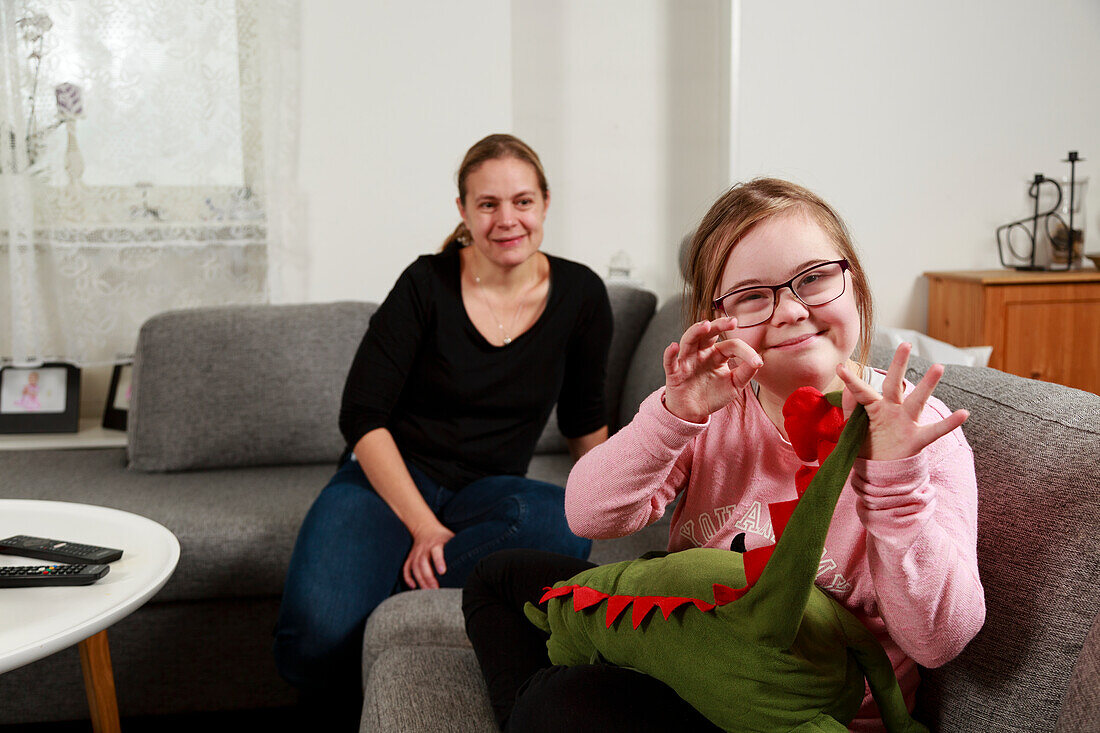 Mother with daughter on sofa