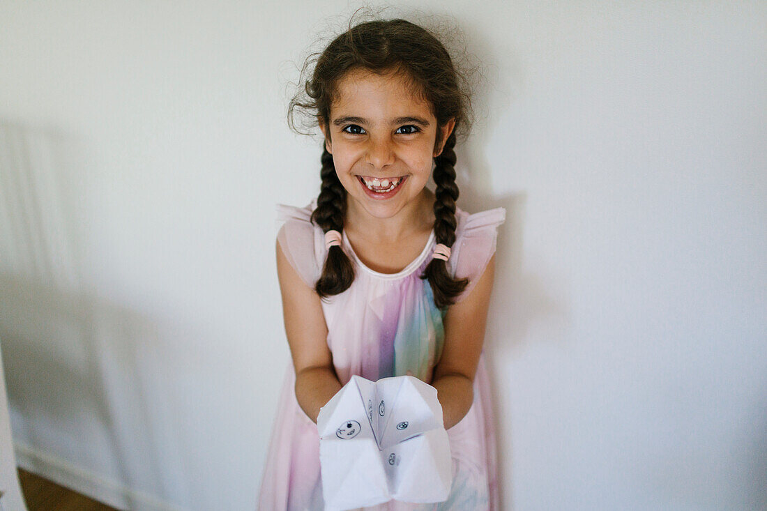 Girl holding paper fortune teller