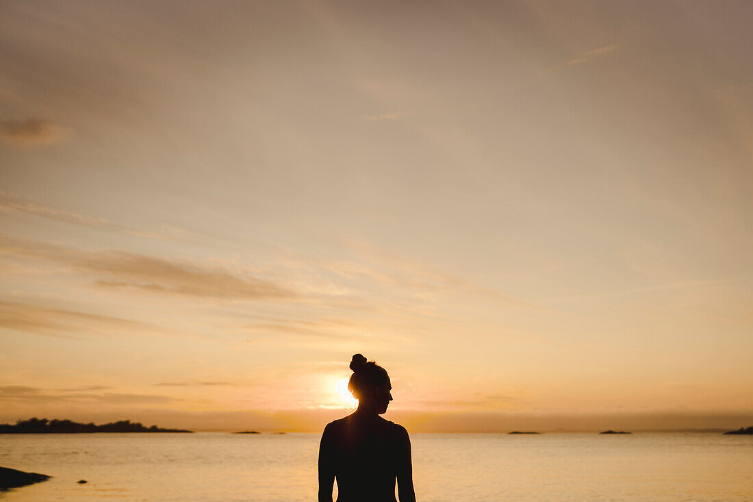 Silhouette of woman at sea