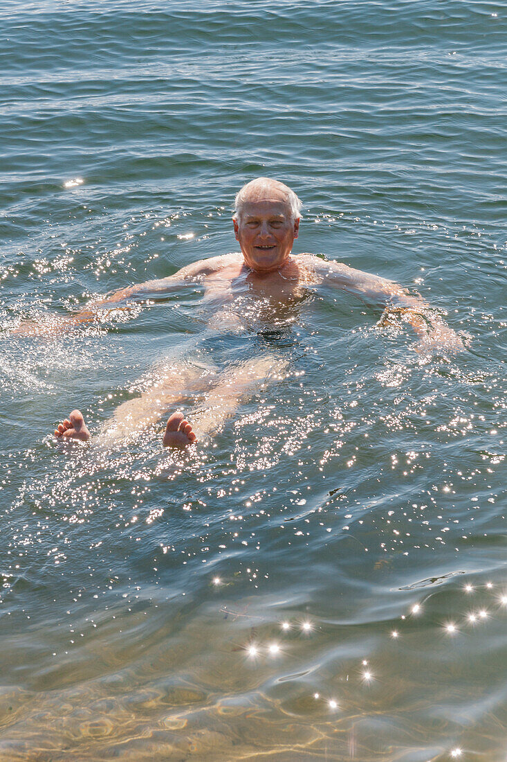 Senior man swimming in sea