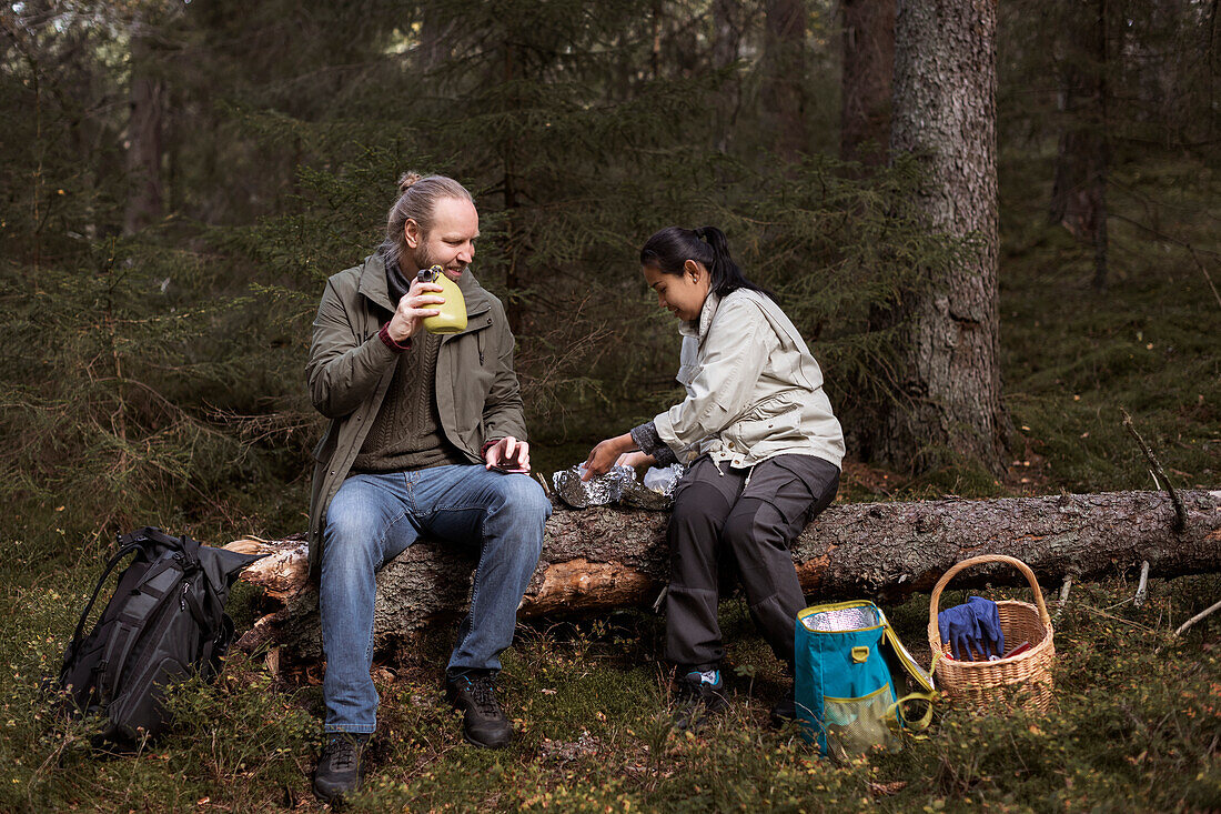 Couple having picnic in forest