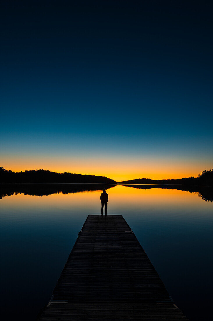 Silhouette of person on jetty