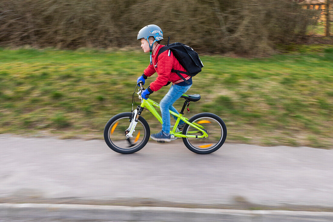 Boy cycling, side view