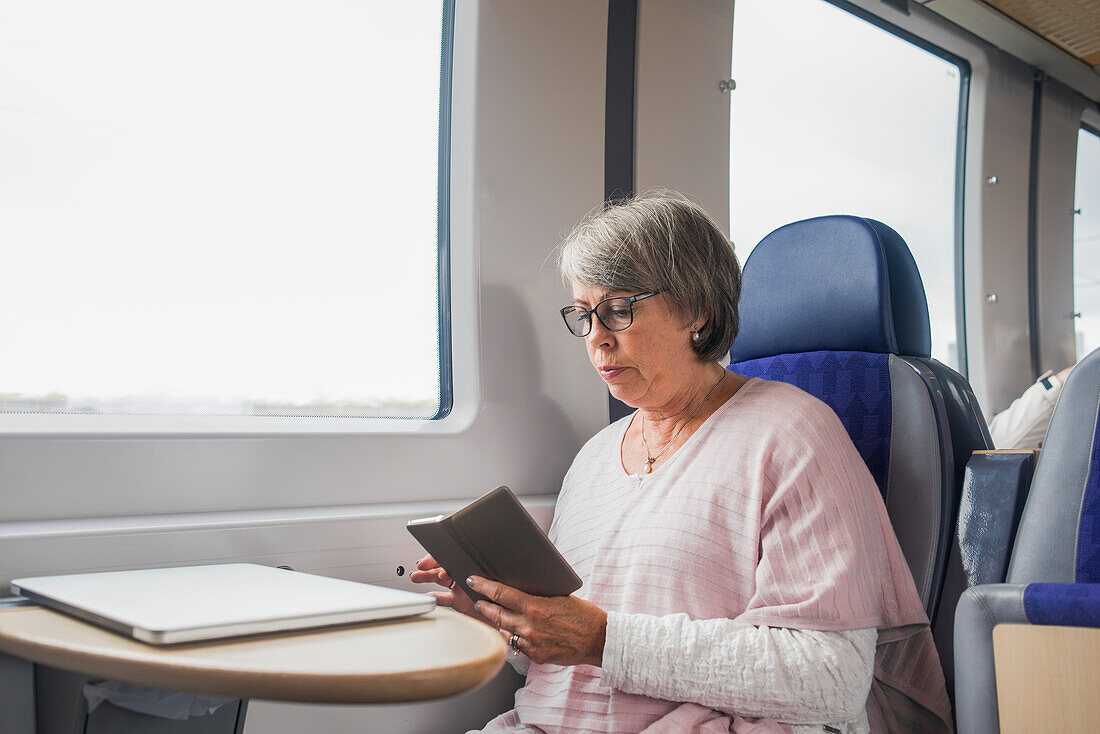 Woman using phone in train