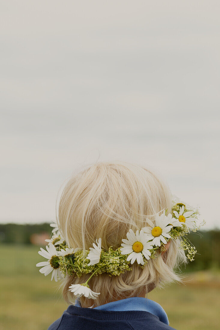 Child wearing flower wreath